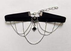 Black velvet gothic choker featuring a black chains design and a gem pendant in the middle. Velvet is 1.2cm wide.This piece fastens with a clasp and 5cm chain at the back. It is to fit neck sizes from 12 to 14.7 inches (31-36cm). If these measurements do not fit you, send me your measurements with your order.This choker is light and not heavy on the neck. I offer FREE product customization. Therefore customized products or choker lengths are available at no extra charge.Chokers are placed in a c