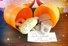 two stuffed animals are in orange containers with a note attached to the top and bottom