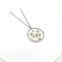 Baby's Breath Pressed Wildflower Necklace | Unique Gift for Her | Gypsophila Resin Necklace | Dried Wildflowers | Handmade Jewelry 》DESCRIPTION * Real Pressed Baby's Breath Flower encased in high quality UV resin * Silver Plated Zinc Metal Alloy Pendant Frame  - Diameter: 25mm in diameter - Thickness: 2mm * Necklace Length: 18 inches 》STAINLESS STEEL CHAIN: * Stainless Steel Necklace Chain * Stainless Steel Jump Ring *Stainless Steel Clasps 》All items, personalized or not are done by HAND with l White Birth Flower Necklace, Nature-inspired White Birth Flower Necklace, Delicate Round Flower Necklace With Pressed Flowers, White Flower Necklace With Pressed Flowers, Delicate Round Pressed Flower Necklace, Delicate White Birth Flower Necklace, White Birth Flower Round Pendant Necklace, White Pressed Flowers Necklace, Nature-inspired White Necklace With Pressed Flowers