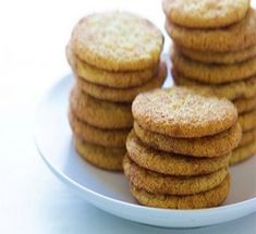 several cookies are stacked on a white plate