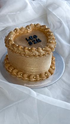 there is a cake that has been decorated with gold icing