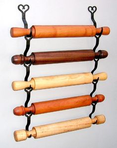 a wall mounted rack with several wooden handles