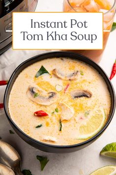 instant pot tom kha soup in a bowl with spoons and lime slices on the side