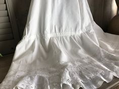 "French Fine Lace Petticoat ca. Early 1900s 4291801 IW Amazing fine cotton/linen and lace petticoat from the early 1900s. Double layered with the under ruffled underskirt. Beautiful lace inserts and tiny tuck seam design with lace bottom. All hand worked. Gathered at the top with a mother of pearl button closure. Measures; 39\" length, 30\" waist, generous size for this era. Beautiful and clean condition with a few small marks and rust spots (somewhat faded), nothing too off putting. There is he White Regency Style Petticoat With Ruffles, Victorian White Ruffled Petticoat, Victorian White Petticoat With Ruffles, White Regency Style Cotton Petticoat, Victorian White Cotton Petticoat, Regency Style White Petticoat For Daywear, White Regency Style Petticoat For Daywear, Victorian Wedding Petticoat With Attached Cancan, Victorian Wedding Petticoat With Cancan