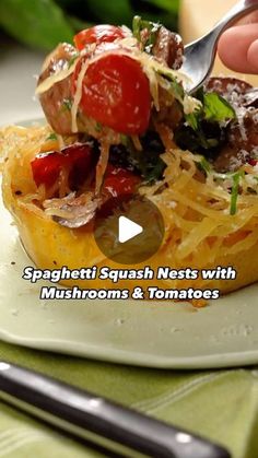 spaghetti dish with mushrooms and tomatoes being spooned into the casserole on a plate