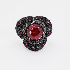 18k White gold, yellow gold and oxidised white gold ring with balck diamonds, rubies and sybthetic center stone. 18.96 grams Black Ruby Ring For Anniversary, Round Black Ruby Ring, Formal Black Rings With Ruby, Black Round Ruby Ring, Elegant Black Ruby Ring, Luxury White Gold Jewelry With Black Spinel, Vintage Diamond Rings With Black Enamel, Luxury Black Faceted Jewelry, Black Heart-shaped Diamond Jewelry