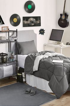 a bed room with a neatly made bed and two guitars on the wall