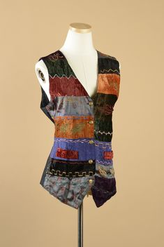 "1980s Creazion Effect abstract bold vest. This vest has large colorblocked stripes with embroidered designs. The embroidered motifs consist of zig zags as well and flowers and leaves. The vest has a v-neck and buttons up the front with 5 gold buttons. The vest has two faux pockets in the front and end terminates with points. The back of the vest is solid black and has a tie to adjust the fit. The front of the vest is 100% rayon and the back is 100% cotton. This vest was made in India and is in excellent condition.  The Size On The Tag: Medium Shoulder to Shoulder: 3.5\"  Sleeve Width: 13\"  Bust: 38\"  Waist: 34\"  Hips: 38\"  Length: 27\"" Crochet Bolero Pattern, Bolero Pattern, Noir Uni, Patchwork Vest, Embroidered Motifs, Floral Vests, Embroidered Designs, T Dress, Upcycled Fashion