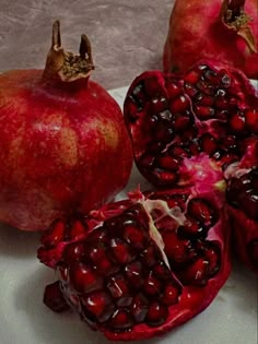 the pomegranates are cut in half and ready to be eaten on the plate