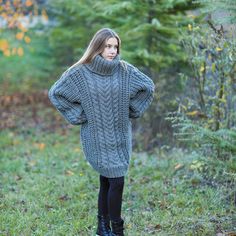 "Long Wool Sweater, Oversized Wool Pullover, Cable Knit Sweater DETAILS - Made from 100% high natural quality wool/pure wool - The model is 170 cm tall (regular S) - The sweater on picture is size 4XL - As mostly all models in our shop the sweater is loose fit - Colour on photo - gray TAKING CARE - Hand wash only - Dry gentle. STANDARTS MOLIMARKS SIZING CHAT - Chest length - measured from armpit to armpit - Garment length - measured from shoulder to the bottom part of the sweater - Sleeve length Oversized Cable Knit Turtleneck Cardigan, Oversized Turtleneck Cable Knit Cardigan, Winter Gray Knitted Sweater Dress, Gray Knitted Sweater Dress For Winter, Hand Knitted Gray Sweater For Fall, Gray Hand Knitted Sweater For Fall, Gray Hand-knitted Sweater For Fall, Oversized Knit Sweater For Winter, Oversized Gray Knitted Sweater