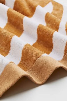 an orange and white blanket laying on top of a table