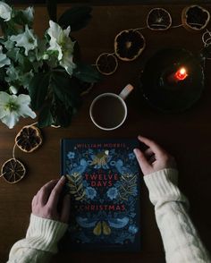 a person is reading a book on a table