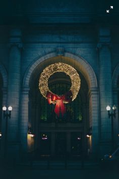 an entrance to a building decorated with christmas lights