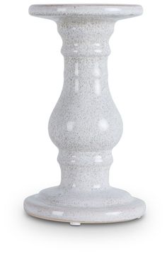 a white vase sitting on top of a table