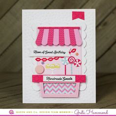 a handmade birthday card with a pink and white cake on the front, decorated with candy