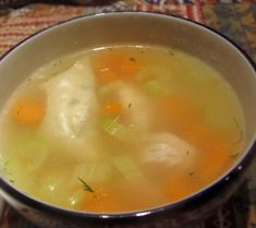 a bowl filled with soup sitting on top of a table