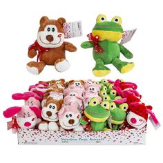 two stuffed animals in a box with valentine's day decorations on the bottom and another stuffed animal sitting next to it