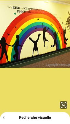 an image of children playing in front of a rainbow painted on the side of a wall