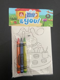 two crayons are sitting in front of a coloring book