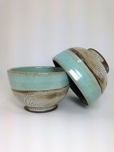 two bowls sitting next to each other on a table