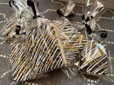 three bags filled with chocolate and gold sprinkles on top of a table