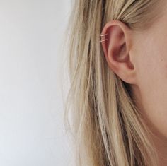 a close up of a person with ear piercings