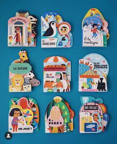 several children's magnets are arranged on a blue surface, with different illustrations