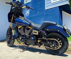 a motorcycle parked in front of a blue building