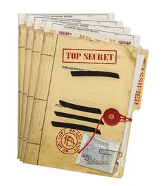 the top secret files are stacked on top of each other, with stamps and envelopes