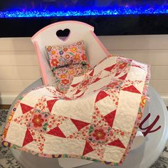 a bed with a quilt on top of it