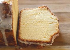 a close up of a piece of cake on a cutting board with one slice cut out