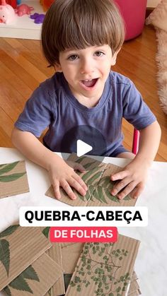 a young boy sitting at a table with paper cut outs in front of him and the words quebra - cabeca de folas on it