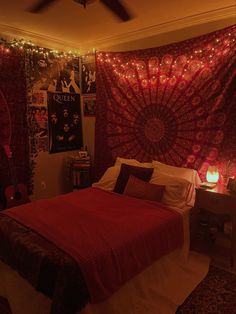 a bed room with a neatly made bed and lights on the wall above it's headboard