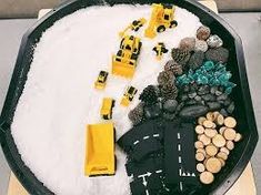 a cake decorated with construction vehicles and snow