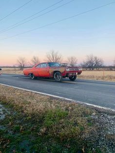 two cars are parked on the side of the road near power lines and telephone poles