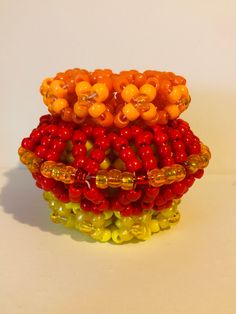 Red, orange, and yellow rotator cuff. 4 inches long and 5 inches wide, Fits a 7-inch wrist, made with stretchy elastic. Vibrant Yellow Beaded Bracelets As Gift, Vibrant Red Bracelets For Gift, Rotator Cuff, Orange And Yellow, Beaded Bracelets, Cuff, Lake, Elastic, Orange