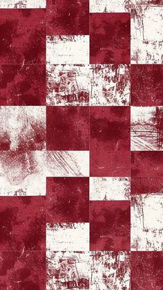 a red and white checkerboard pattern with grungy paint on the surface