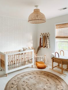 a baby's room with white walls and furniture