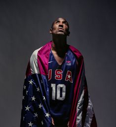 a man with an american flag draped around his shoulders