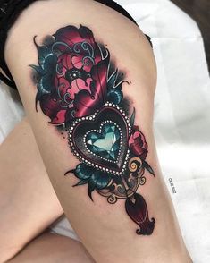 a woman's thigh with a heart and flowers tattoo design on her left leg