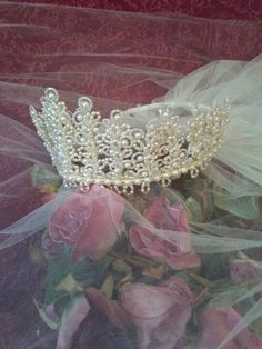 a tiara is sitting on top of some flowers