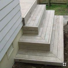 the steps are made out of wood and have been placed on the side of the house