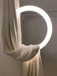 a circular light that is on the side of a curtain