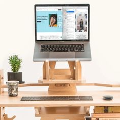 a laptop computer sitting on top of a wooden stand next to a keyboard and mouse