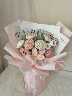 a bouquet of flowers sitting on top of a bed