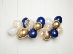 blue, gold and white balloons hanging on the wall