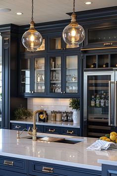 a kitchen with blue cabinets and two hanging lights