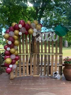 a wooden bench decorated with balloons and numbers