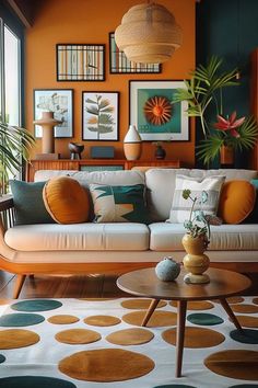 a living room filled with furniture and pictures on the wall next to a coffee table