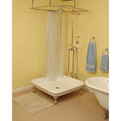 a white bath tub sitting next to a shower